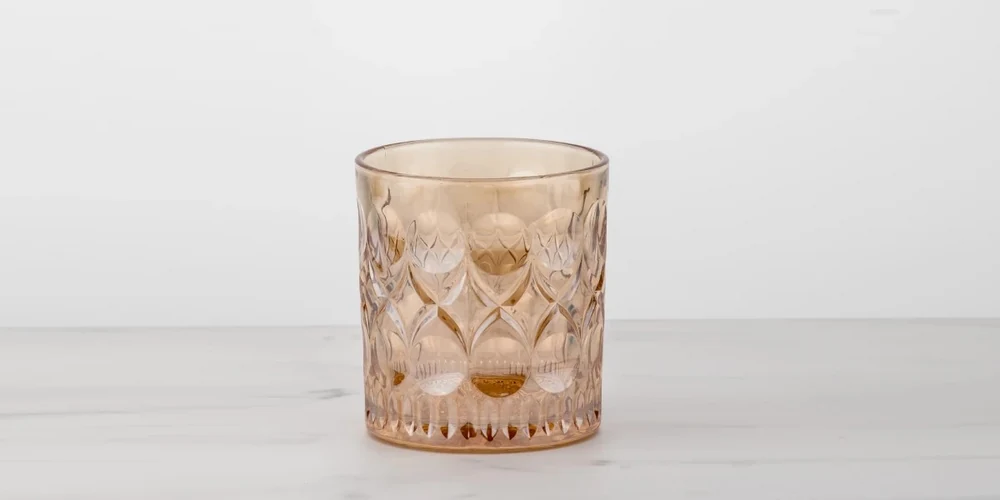 Amber gold electroplated vintage relief whiskey glass with luxury metallic shine