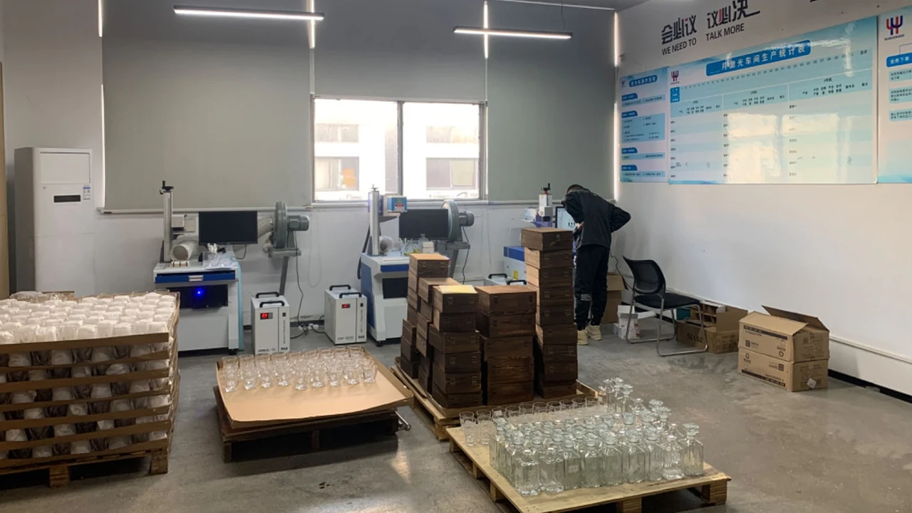 In-house high-precision fiber laser engraving workshop for rapid logo branding on glassware and wooden boxes
